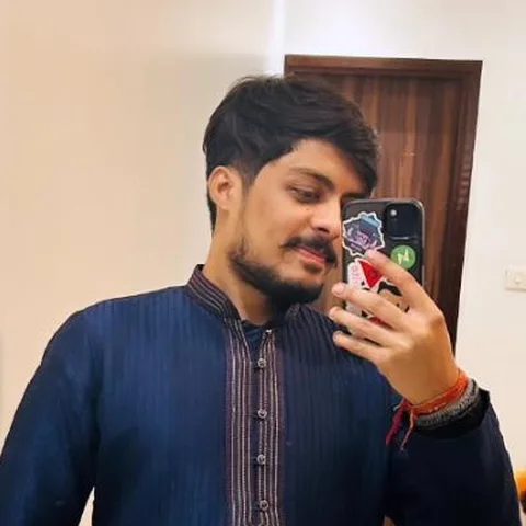 Utkarsh Dixit in a navy kurta, taking a mirror selfie